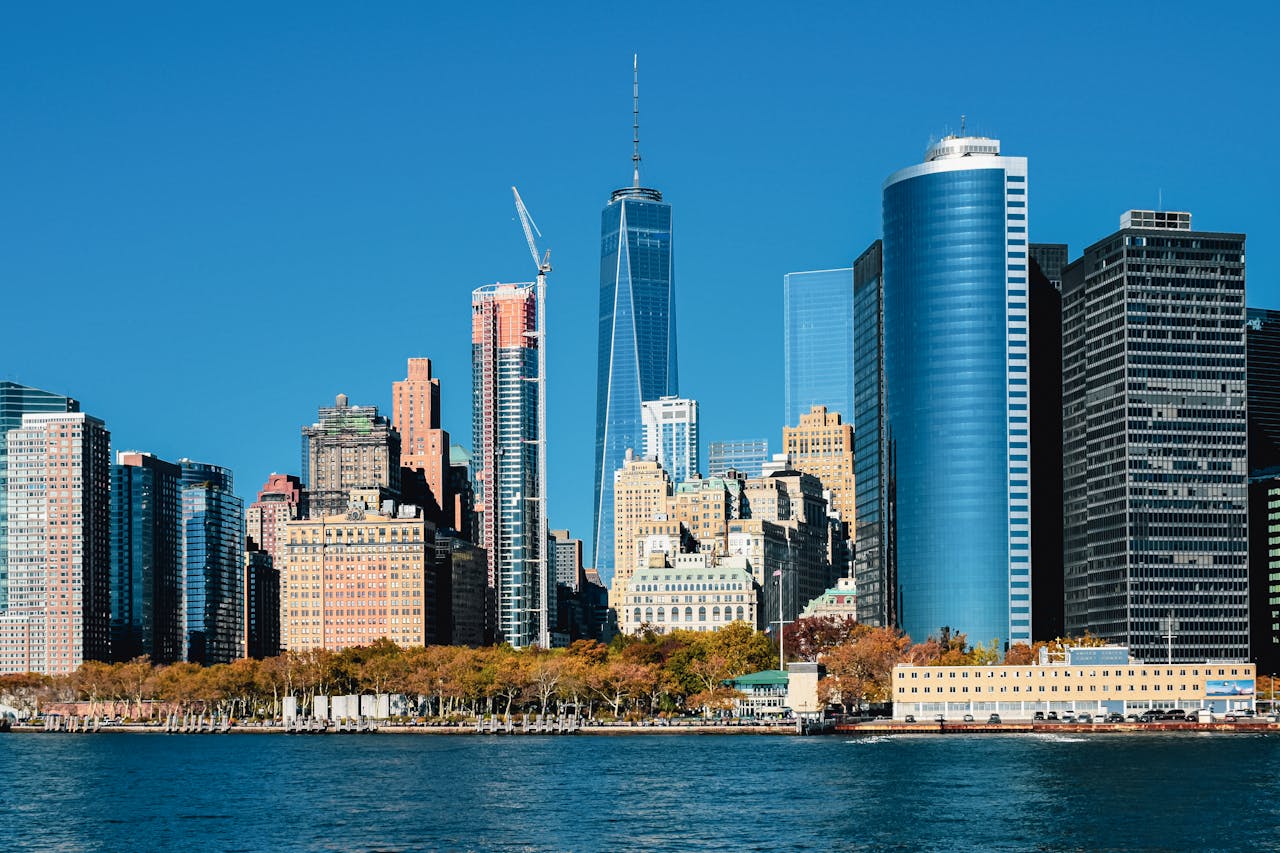 Captivating view of the Lower Manhattan skyline with iconic skyscrapers under a clear blue sky.