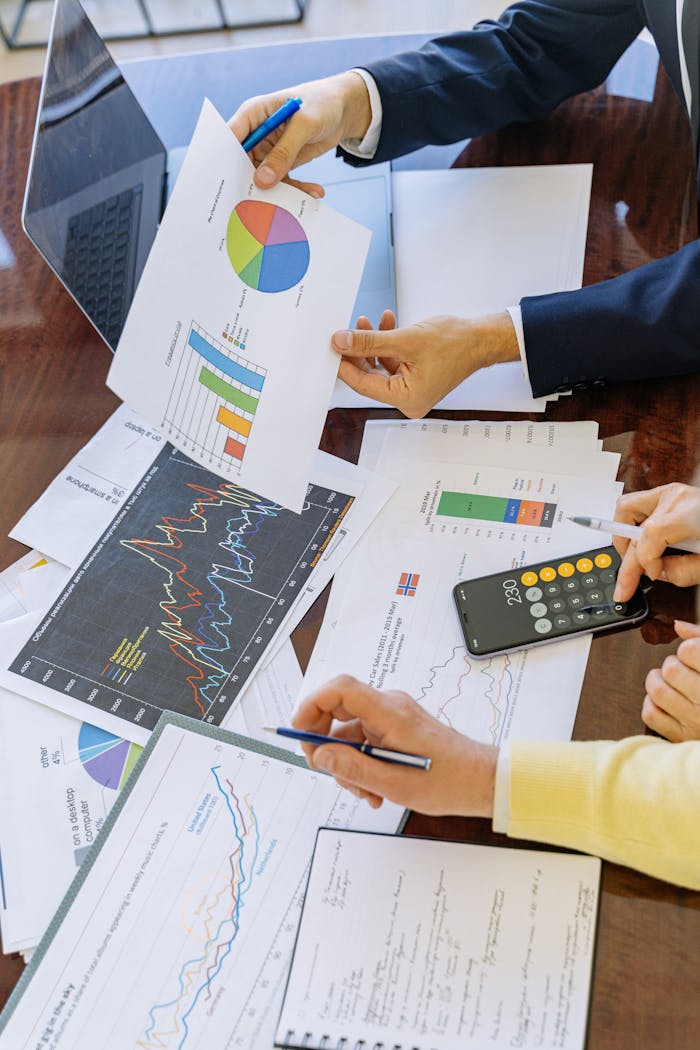 The Art of Drawing Readers In: Your attractive post title goes here Business professionals analyzing financial charts and graphs during a meeting.